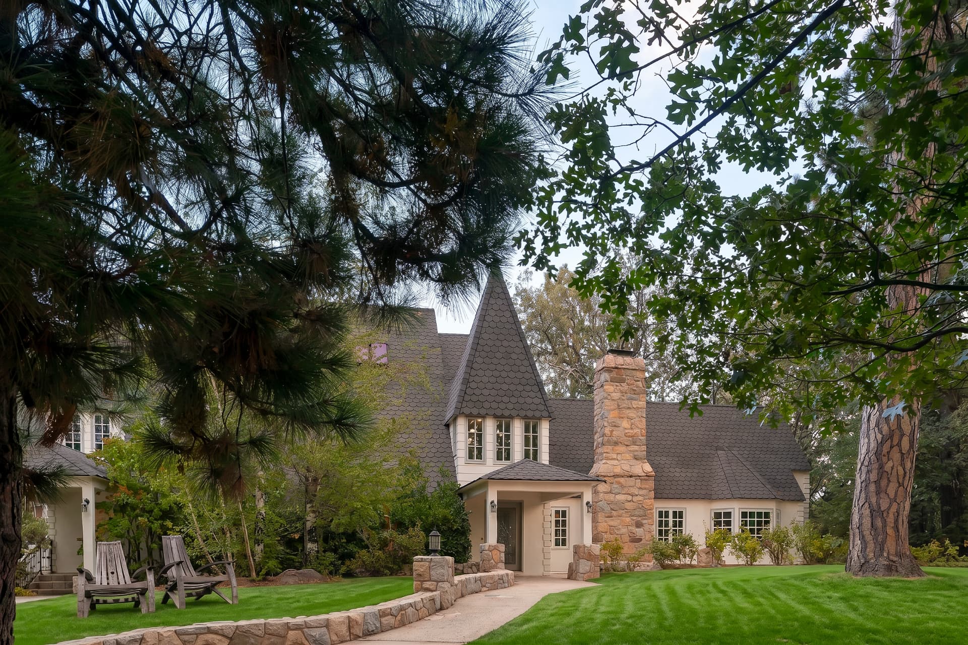 Sherwood estate with its turret, stone chimney and sweeping front lawn
